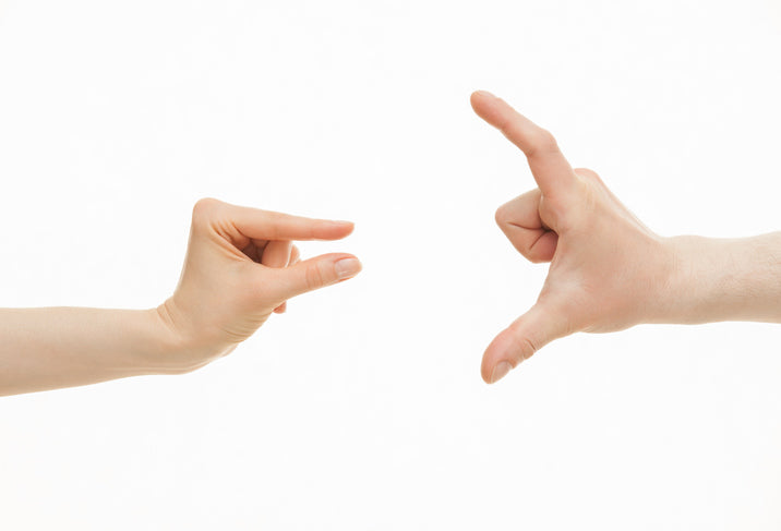 two hands depicting big vs small