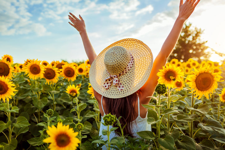 happy lady in field of sunflowers