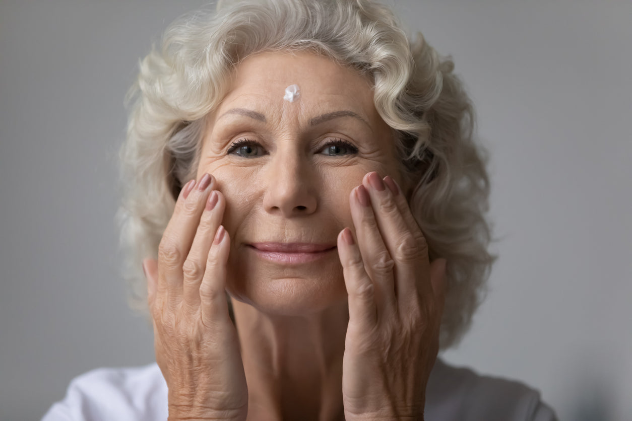 attractive older woman taking care of her skin