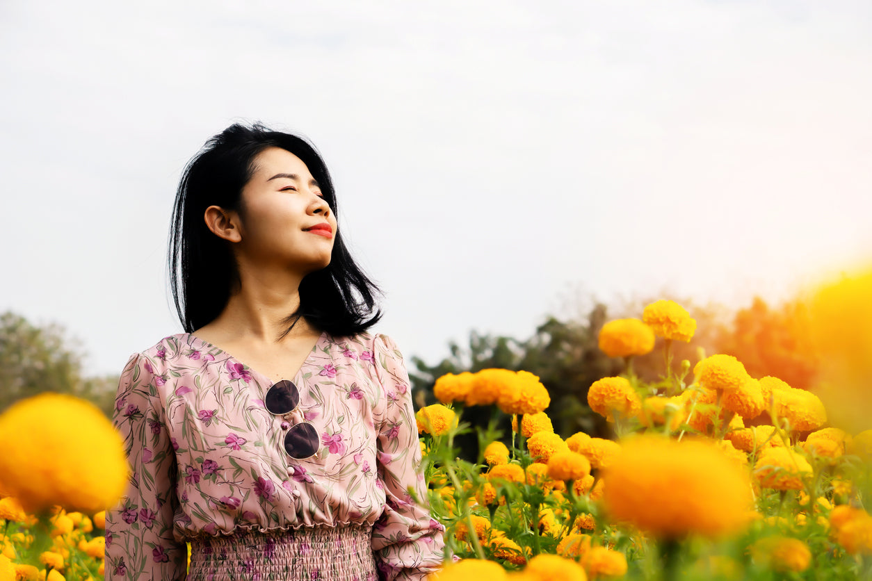 happy woman in a field of flowers
