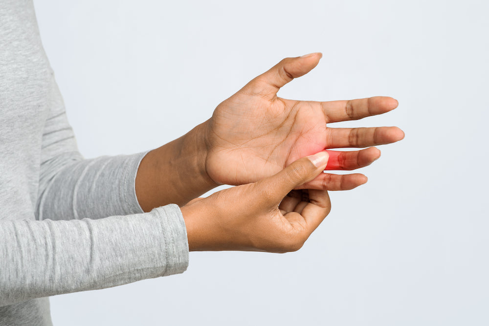 Woman massaging her arthritic hands