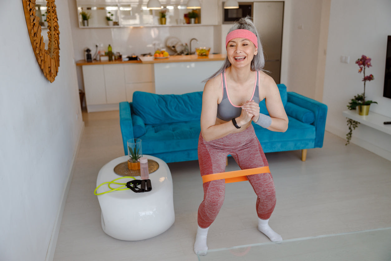 woman working out at home with tubing
